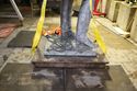 Thumbnail of Bronze base and cap, still attached, and resting on pavement following lifting. Viewed from the south