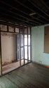 Thumbnail of No.61. Interior, ground storey. Front door and partially dismantled hallway stud wall, facing south-west