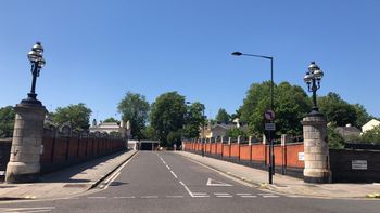 Pair of stone piers with lamp standards to east end of Mornington Street Railway Bridge, viewed from the northeast on Mornington Terrace.