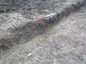 Thumbnail of South-west facing oblique shot of pit [1211] (1m scale)