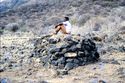Thumbnail of A person sitting on the Cairn