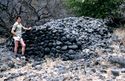 Thumbnail of A person leaning on a Cairn