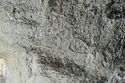 Thumbnail of Pair of eye petroglyphs E12 in quarry bay on exterior of Rano Raraku