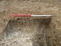 Thumbnail of Area B, N facing longitudinal section of ditch [1025] cutting pit [1022], 1M scale, view from N