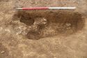 Thumbnail of Working shot of pit [1032] and post-hole [1054], facing north-west. From Archaeological Recording at West of Culworth, Northamptonshire, England.