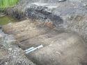 Thumbnail of Oblique shot of NW facing section of trench283 showing (2834), E direction, 1m scale