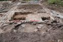 Thumbnail of Trench 7 overview showing fireplace {723} on centre left adjacent to walls {713} and {719}. View NNW, 2m scale