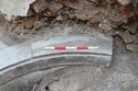 Thumbnail of Trench 1, upper curved stonework of plunge pool {109}, view SSW, 0.5m scale
