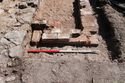 Thumbnail of Trench 7 fireplace {717} and timber (728), view SE, 1m scale