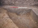Thumbnail of 110490_to_110498_Mitigation_Image_0297, Set Piece Excavation area 1, south-east facing section of ditch 1116 (part of group 106) and pit 1118.