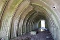 Thumbnail of 110497_HBR_Image_032, Historic Building Recording Report 110497.03 Plate 32, view of interior of Air Raid Shelter 1, showing the joins of the pre-cast concrete arches, with the north-eastern doorway beyond.