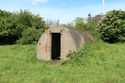 Thumbnail of 110497_HBR_Image_036, Historic Building Recording Report 110497.03 Plate 36, view of Air Raid Shelter 3, with truncated escape hatch projecting from the roof.