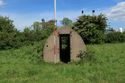 Thumbnail of 110497_HBR_Image_037, Historic Building Recording Report 110497.03 Plate 37, view of western elevation of Air Raid Shelter 3, with truncated escape hatch projecting from the roof.