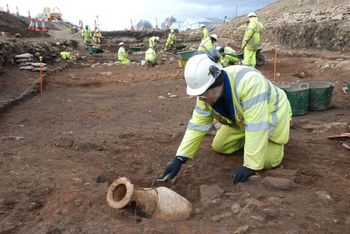 Working shot of an amphora being excavated