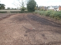 Thumbnail of General view of the site after cleaning, showing a concentration of metal working debris. Land drains to left of scale. View from the southeast. Two 1m scales.