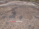 Thumbnail of Pre-excavation view of [F10] and [F11] (top of cleaned area) and probable furnace basess [F20] and [F22] 1m scale, view from the west.