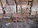 Thumbnail of <em>E-facing view of boulder plinth (611) under western gable wall (Building 4)</em> <br  />(FEN15_21.jpg)