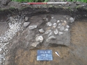 Thumbnail of Photograph depicting a cluster of stones [103] taken during archaeological evaluations at Milken Lane, Ashover, Derbyshire (1m scale)