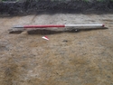 Thumbnail of North-East facing section of footpath [203] uncovered during archaeological evaluations at Milken Lane, Ashover, Derbyshire (1m scale) No Board