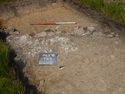 Thumbnail of Photograph depicting a wall foundation [503] at the western end of trench 5. Taken during archaeological evaluations at Milken Lane, Ashover, Derbyshire (1m scale)