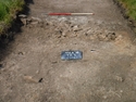 Thumbnail of Photograph depicting a wall foundation [506] at the eastern end of trench 5. Taken during archaeological evaluations at Milken Lane, Ashover, Derbyshire (1m scale)