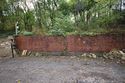 Thumbnail of South eastern extent of red brick retaining wall, facing south west. Scale 2m.