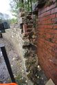 Thumbnail of Detailed view of the link between the red brick retaining wall and the gritstone wall, facing east. It is likely this wall predates the red brick wall.