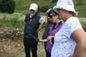 Thumbnail of The Ardnamurchan Community Archaeology group with Mhairi Maxwell of the ACCORD team examining preliminary results on a tablet in the field. <br/> (Ardnam_Production_Images_01.jpg)