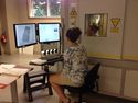 Thumbnail of PhD Student Amy working on the microCT scanner