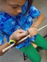 Thumbnail of Third grade student learning to fletch an arrow.