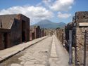 Thumbnail of Via delle Scuole streetscape in Region 8, Pompeii looking towards Mt Vesuvius. Copyright Sera Baker, 2016.