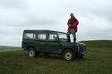Thumbnail of Mike Middleton out on fieldwork, getting a better view from the bonnet of his vehicle