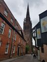 Thumbnail of View of Coventry Cathedral spire along Pepper Lane, framed by The Golden Cross and County Hall