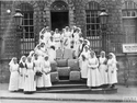 Thumbnail of Members of the Stamford and District Needlework Guild and Hospital Supply Depot standing by hospital materials. IWM (Q 108285).