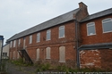 Thumbnail of Cullompton Drill Hall, former workhouse, in use by 1910 as base for G Company, 4th Battalion Devonshire Regiment and D Company 7th Battalion (Cyclist) Devonshire Regiment. Also used as drill station for A Squadron, Devon Yeomanry (Fore Street, Cullompton, Mid Devon, Devon). Front elevation.