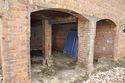 Thumbnail of Interior of Building D showing original internal wall, looking S
