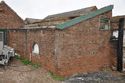 Thumbnail of Southeast and southwest elevations of Building F showing lunette-shaped hatch (later blocked) for feeding kitchen waste, looking N