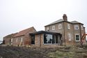 Thumbnail of Farmstead and farmhouse looking E. Newly extended farmhouse and rebuilt outbuilding in foreground (not included within survey)