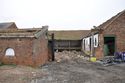 Thumbnail of Gateway into yard with pigsty (building F) on left and the livestock range (Building E) in centre and on right, looking NE