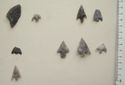 Thumbnail of Close-up of barbed and tanged arrowheads (Fig 88: Row 3 no. 2-4; Rows 4-5) and leaf shaped arrowhead (Fig 88.jpg: Row 4 no. 1)