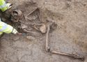Thumbnail of Figure 4.7: Cataractonium: Skeleton 20957 under excavation in Grave 20955, viewed from the south-west.