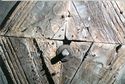 Thumbnail of Detailed views in raking light of some of the original painted decoration that is a cross botonny inside a band of four grooves now showing as relief within the weathered timber surface:  south transept panel C/6 lower left C/7 lower right