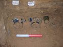 Thumbnail of The glass squat jars <33>, <34> & <35>, found on their sides adjoining the east wall of the chamber.