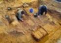 Thumbnail of Archaeologists at work on the body area (left) and the iron weapons (right)