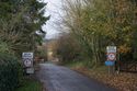 Thumbnail of English side, looking N down approach road, warning signage. Report plate 127.