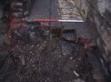 Thumbnail of Trench 10. Section through inspection pit [1001] showing brick floor and floor's concrete sub base and concrete footings of pit's side walls