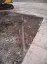 Thumbnail of Trench 12, concrete layer [1203]. Looking north-west showing rail chairs [1230]
